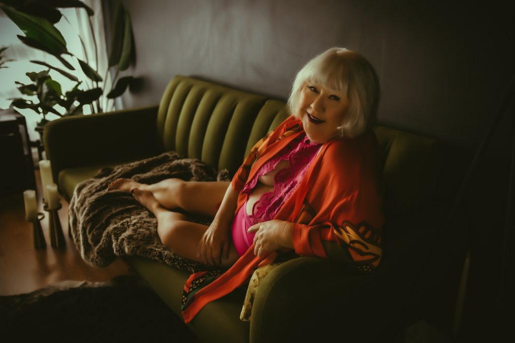 boudoir photo of a woman on a green couch in a Sacramento boudoir studio