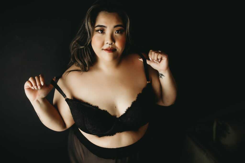 curvy Dark haired asian woman in black bra and sheer skirt