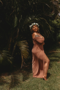 Woman wearing a flower crown during her boudoir confidence journey in a tropical outdoor portrait celebrating healing and self-love.