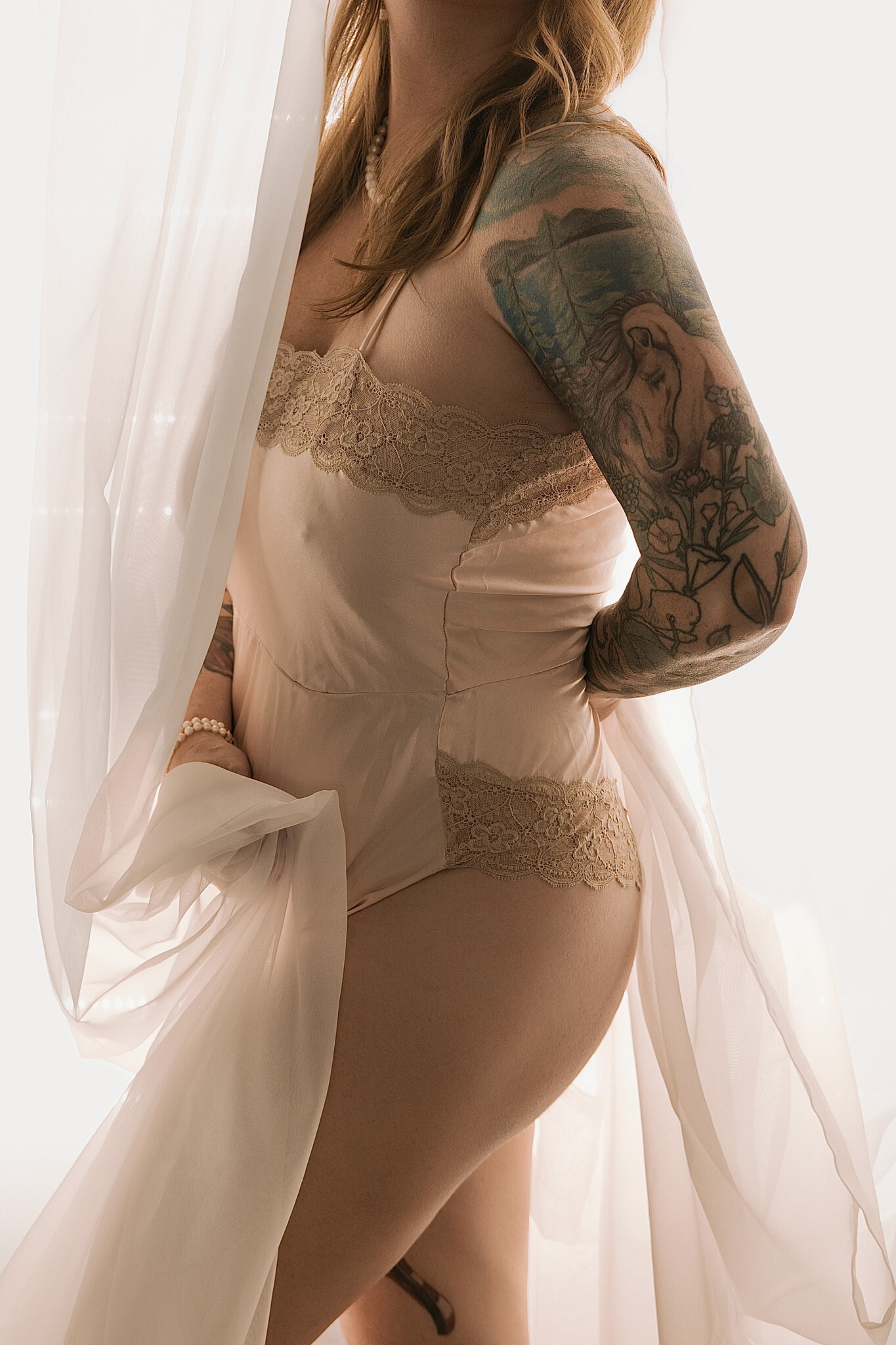 Boudoir photography for every body in Sacramento — an elegant, tasteful backlit portrait in blush lace at Boudoir by Olin